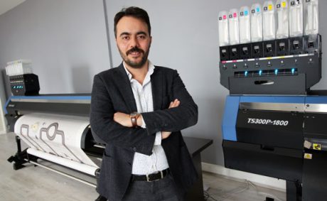 man in front of printer